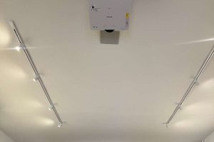 Ceiling-mounted projector installed in a conference room.