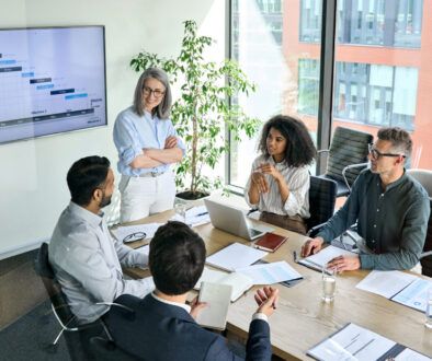 Diverse corporate team working together in modern meeting room office.